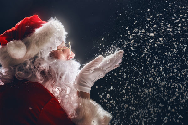 Merry Christmas and happy holidays! Santa Claus blows snow.